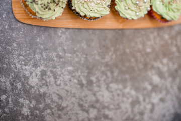 Cupcakes with green cream and gold powder