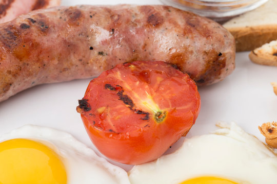 Fragment of english breakfast with the sausage.