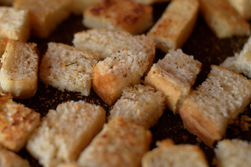 Rusks in the pan. Homemade toasted bread, croutons. Bread in salt, pepper, seasoning, crunchy salad.