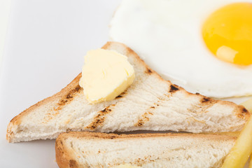 Fragmnet of breakfast with toast and egg.