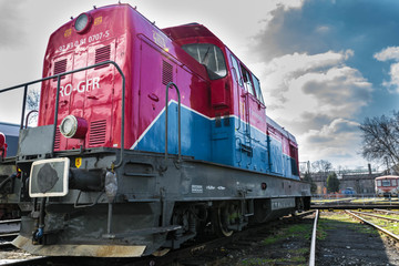 Fototapeta na wymiar Red blue diesel locomotive stationary on railway.