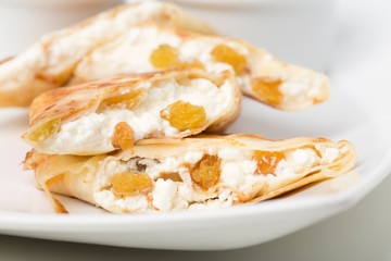 Pancakes stuffed with cottage cheese and raisins.