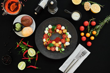 Appetizing food laid out on a black background. Food photography for restaurant menu