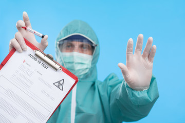 Doctor holding test tube with Positive Coronavirus or Covid-19 test blood sample - Concept of...