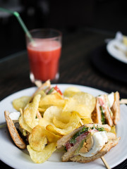 Club sandwich, chips and juice