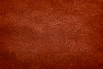 A chocolate brown background with marbled texture.