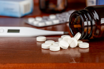 Pills bottle and round white pills