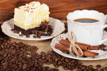 retro cups with hot coffee and a cookie with vanilla chocolate cream