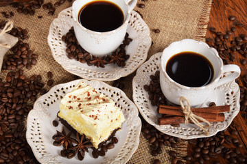 retro cups with hot coffee and a cookie with vanilla chocolate cream
