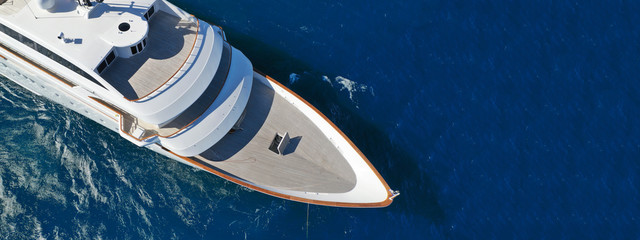 Aerial drone ultra wide photo of luxury mega yacht with wooden deck anchored in deep blue sea of...