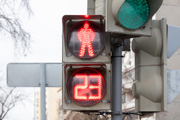 The traffic light shows red, which prohibits traffic for people.