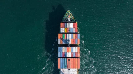 Foto op Aluminium Aerial view container ship carrying container box global business cargo freight shipping commercial trade logistic and transportation oversea worldwide container vessel.Container cargo freight ship. © Kalyakan