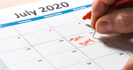Tax day filing deadline pushed back to July 15 marked on calendar due to Coronavirus Covid-19.