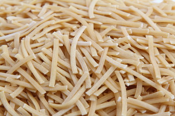 Dry uncooked vermicelli as a background texture. Close-up, top view