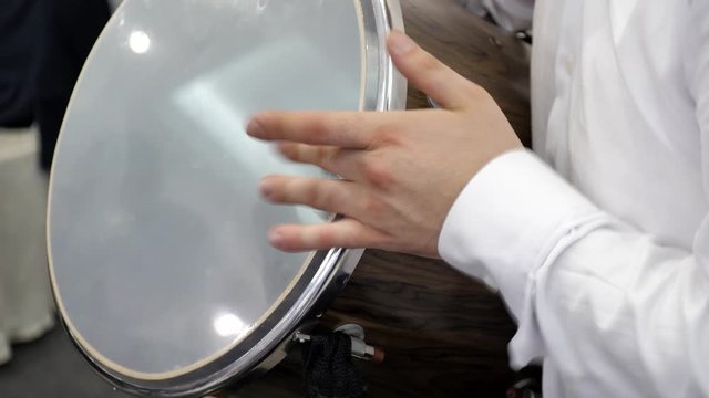 Close-Up of a human hands. A drummer. The man plays the drum with his hands