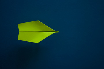 Flat lay of paper plane on pastel blue color background