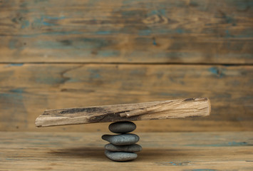 Wooden blank plank balancing on stone. Copy space