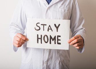 Doctor holding STAY HOME sign. Begging People with hashtag #StayHome to Fight Coronavirus. Anti nCoV Covid-19 Virus