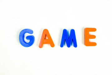 GAME word written in different colored letter blocks on a white background