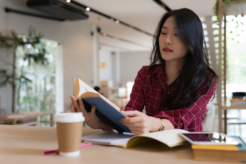 Close up of young business woman big smiling from ear to ear while holding tablet in her hand at table, successful concept