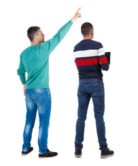 Obraz premium Back view of two man in sweater pointing.