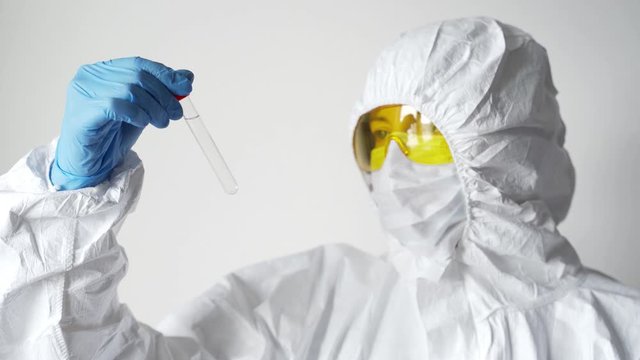 Young caucasian scientist takes samples for Covid 19 vaccination, Coronavirus vaccine for 2019-nCoV COVID virus. Female laborant holding medical tube with samples of vaccine. Preventive medications