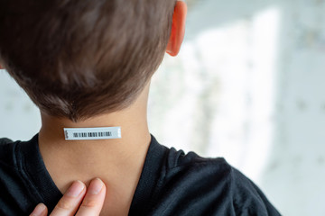 Bar code is on  a child 's neck.  Clone of DNA and human genome. 