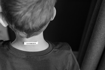 Bar code is on  a child 's neck.  Clone of DNA and human genome. The concept child trafficking,...