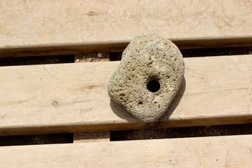 A large stone with a through hole. Natural sea stone with a hole as Chicken God or Lucky stone....