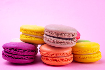 Traditional macaroon macaroon cookies on a pink background