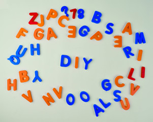 Various different colored letter blocks scattered across a white background