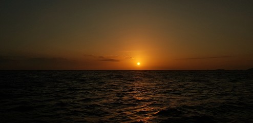 Sunset in the middle of sea
