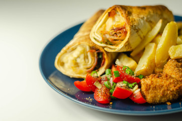 Tortilla wrap with chicken and beechwood smoked bacon served with chicken nuggets and chips