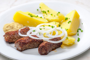 cevapcici with potatoes and onion