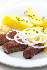 cevapcici with potatoes and onion