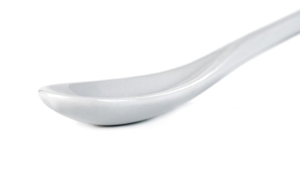 White ceramic spoon isolated on a white background