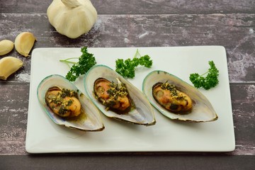 Baked green mussels with garlic butter herb sauce 