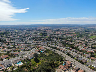 Aerial view of upper middle class neighborhood with residential subdivision houses during sunny day in San Diego, California, USA.