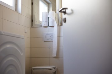 Last couple of toilet paper rolls in bathroom. People attacked to the supermarkets to buy toilet papers as many as they can find due to corona virus quarantine.