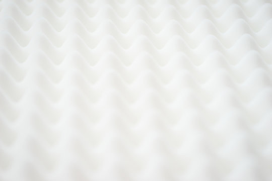 White gradient abstract background with many waves at different angles.