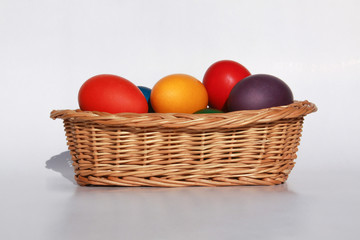 Easter eggs colors in basket white background