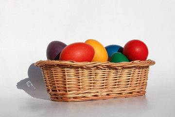 Obraz na płótnie Canvas Easter eggs colors in basket white background