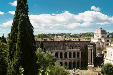Fototapeta premium View of the ancient city center of Rome. Ruins, tourist places of Rome, coliseum, Roman forum. The cultural heritage of ancient Italy.