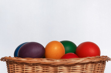 Easter eggs colors in basket white background