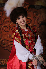 Obraz premium Kazakh national wedding dress. Ornaments and embroidery on fabric. Red dress. Traditional dress of the Kazakh bride.