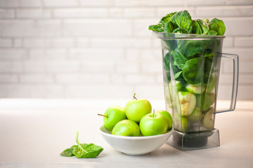 green set of products for a healthy smoothie was put in a blender: lemon, apple, avocado, spinach. Morning detox for a healthy lifestyle, weight loss, ketone diet, raw food diet