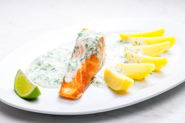 baked salmon with creamy dill sauce and potatoes