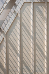 Obraz premium Sunlight and shadow on surface of white wooden roof truss structure under construction in vertical frame