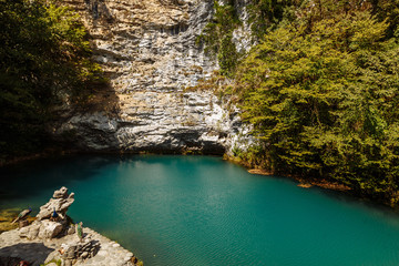 A beautiful blue lake at the foot of a mountain and forest in the Republic of Abkhazia. Natural monument.