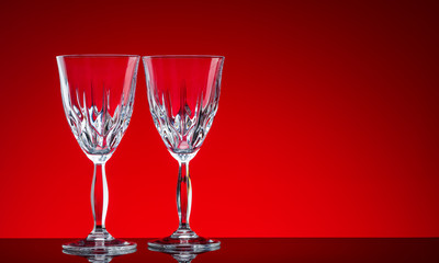Crystal glasses shot close-up on a red background